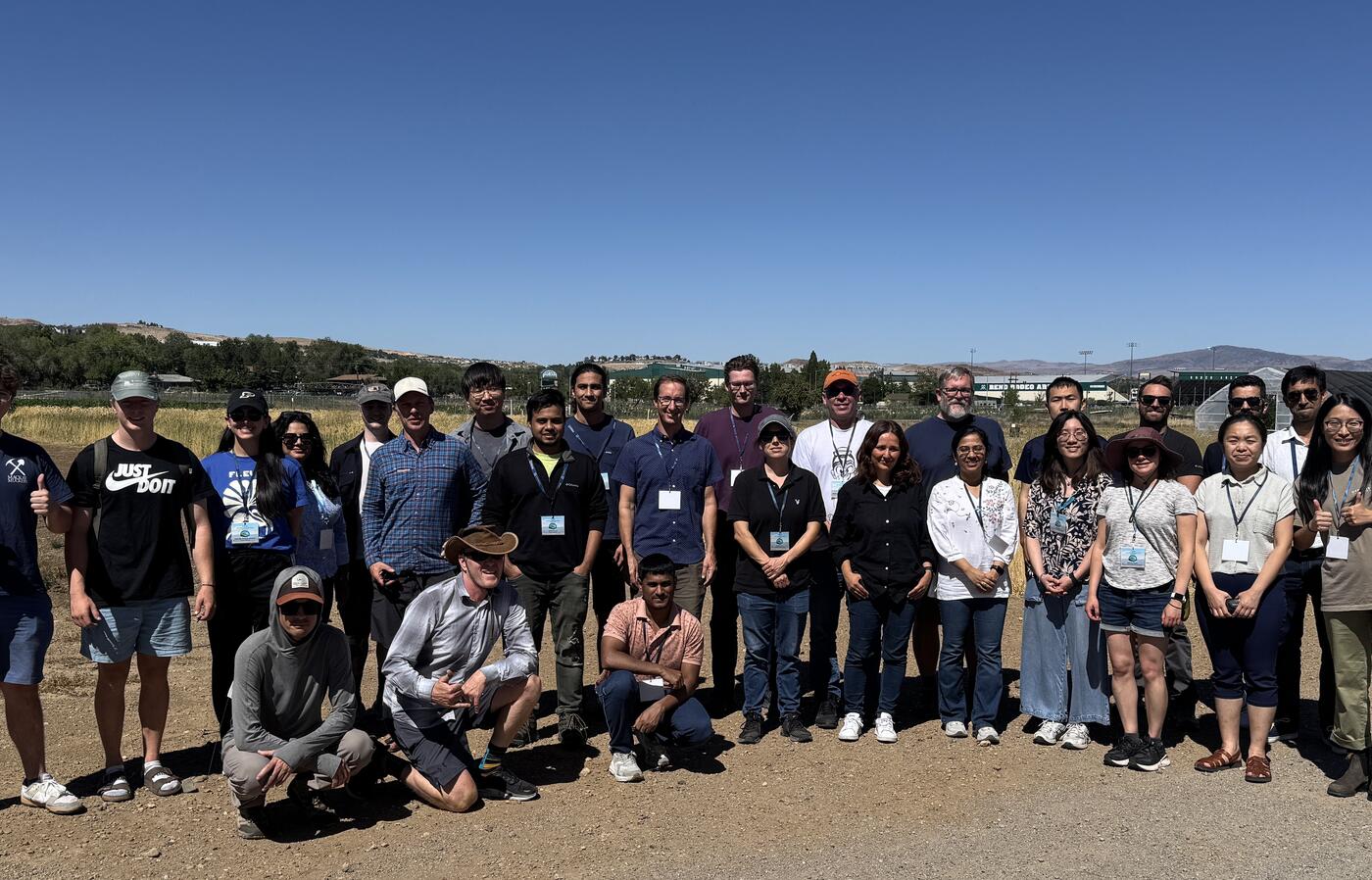 workshop participants stand for group photo outside.