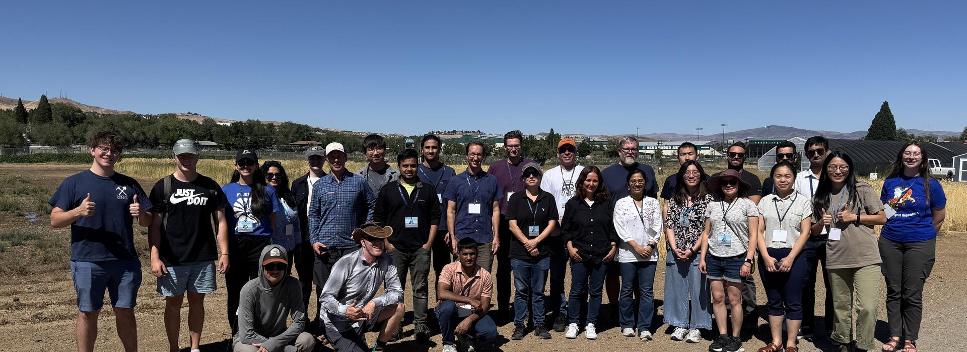 workshop participants stand for group photo outside.